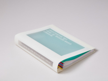 The folder is made of translucent plastic. White is silk-screened onto the plastic to create a 'window' on the front, spine and back of the binder.